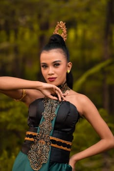 The fierce face of an Indonesian woman wearing makeup on her face and a black costume after a dance performance at the festival