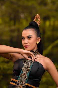 The fierce face of an Indonesian woman wearing makeup on her face and a black costume after a dance performance at the festival