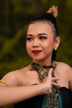 Beautiful face of a Javanese woman in a traditional dance costume before the dance performance begins inside the festival