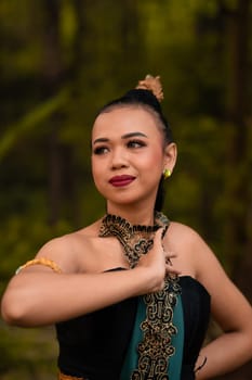 Beautiful face of a Javanese woman in a traditional dance costume before the dance performance begins inside the festival