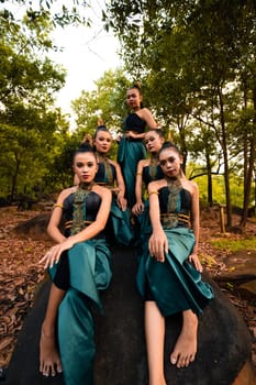 A Group of Balinese people wearing traditional green costume before the dance festival begin in the village