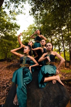 A Group of Balinese people wearing traditional green costume before the dance festival begin in the village