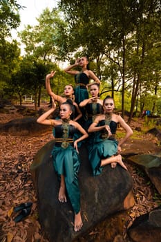 A Group of Balinese people wearing traditional green costume before the dance festival begin in the village