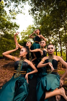 A Group of Balinese people wearing traditional green costume before the dance festival begin in the village