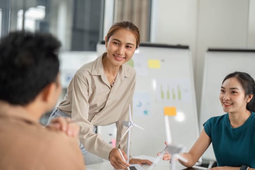 A young woman presents her ideas on ESG goals to her colleagues, fostering a collaborative environment.