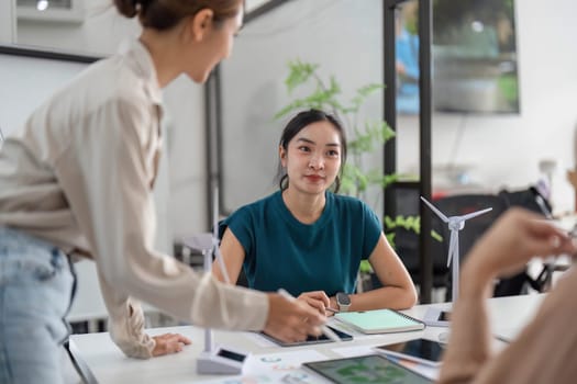 A team discusses ESG initiatives, emphasizing sustainable practices and collaborative decision-making.