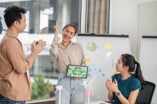 A dynamic team engaging in a discussion about ESG metrics and sustainable business practices in a collaborative office environment.