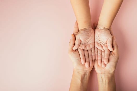 Family day concept, Top view of parents and kid holding empty hands isolated on a color background. Celebrating togetherness and support.