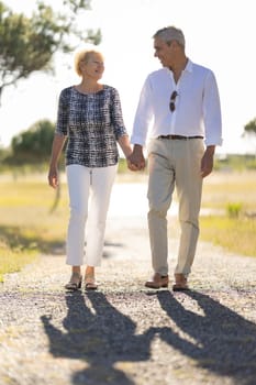 Smiling senior couple enjoying a walk together in the countryside