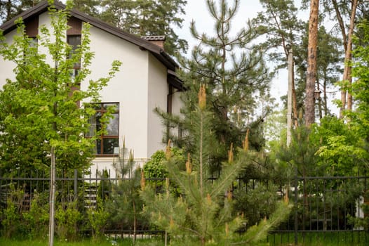 Beautiful new home exterior with covered porch and green grass on bright sunny day with blue sky. High quality photo