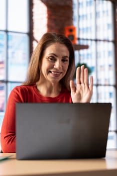 Female student trying to learn a new language from her home office, attending an online class lesson to develop her skills. Ambitious woman solving language learning exercises and tasks.