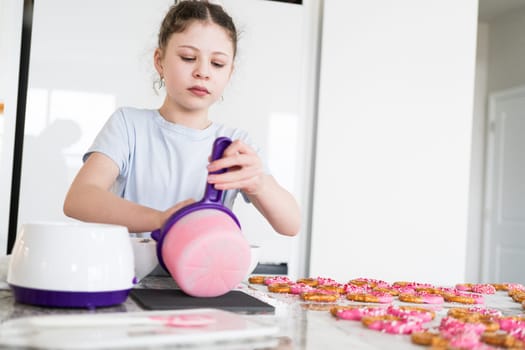 With focused attention, this budding culinary artist dips pretzels into a pot of melted chocolate, creating sweet delights in the warmth of a well-lit home kitchen.