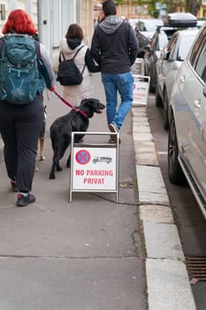 Karlovy Vary, Czech Republic – April 19, 2025: No parking sign in front of a hotel in Karlovy Vary with the inscription No Parking private and some passers-by