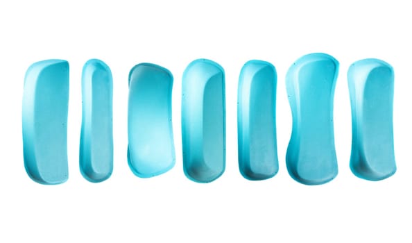 Set of blue climbing pinches arranged in a row, isolated on white. Indoor climbing holds for training or competition. Online shop image