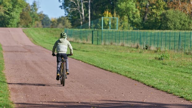 Young sporty cyclist on a path in the Herrenkrugpark in Magdeburg