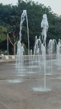 Water fountains splashing street building architecture travel shotlisttravel place destination objects city centre town trees green nature park summer tree vertical place destination objects . High quality photo