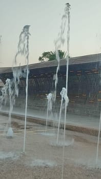 Water fountains splashing street building architecture travel shotlisttravel place destination objects city centre town trees green nature park summer tree vertical place destination objects . High quality photo