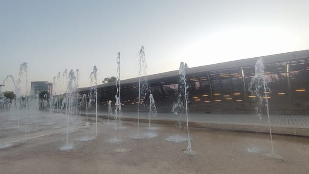 Water fountains splashing street building architecture travel shotlisttravel place destination objects city centre town trees green nature park summer tree vertical place destination objects . High quality photo