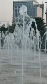Water fountains splashing street building architecture travel shotlisttravel place destination objects city centre town trees green nature park summer tree vertical place destination objects . High quality photo