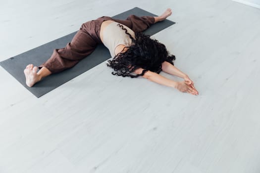 Brunette Yoga Woman Doing Asana Gymnastics On White Floor