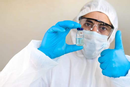 Medicine in a bottle in the hands of a doctor. Selective focus. vaccine