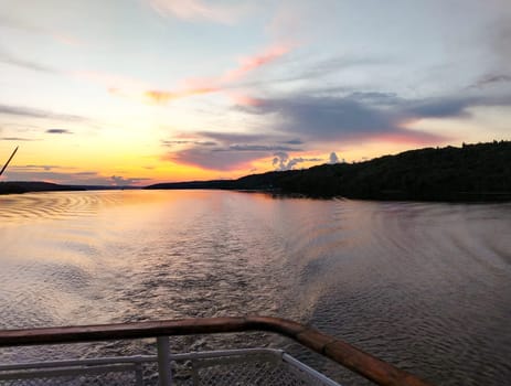 Sunset view and water mark during a tourist cruise, romantic evening.