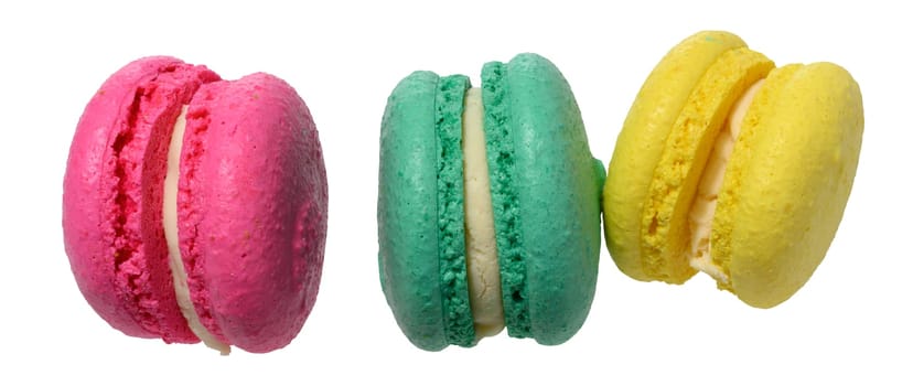 Three multicolored macarons with white filling on isolated background
