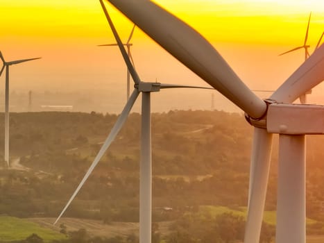 Wind farm field and sunset sky. Wind power. Sustainable, renewable energy. Wind turbines generate electricity. Sustainable development. Green technology for energy sustainability. Eco-friendly energy.