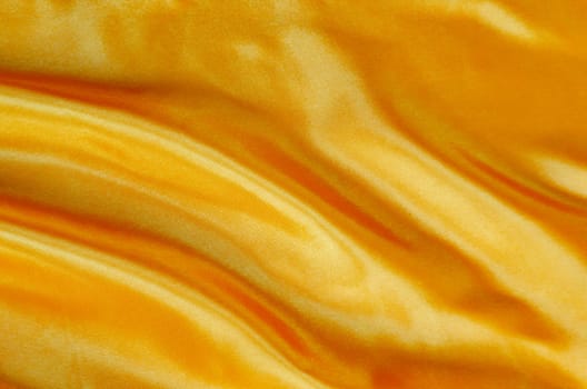 Yellow silk cloth with silky sheen suitable for design and wallpaper background.