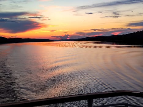 Sunset view and water mark during a tourist cruise, romantic evening.