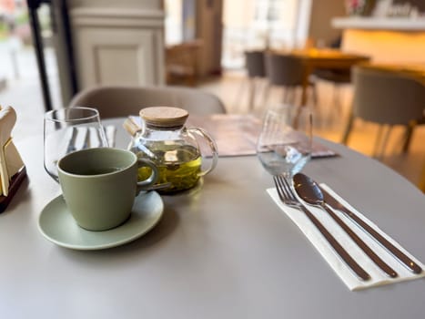 Minimalist cafe tea setting with a focus on herbal tea. Slow living, clarity and simplicity during a midday break