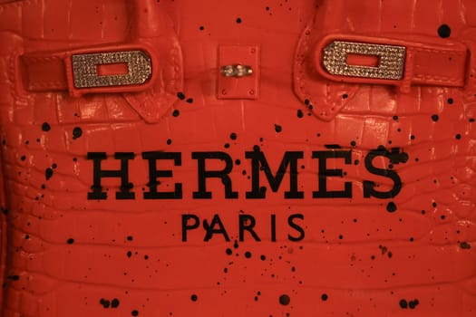 Paris , France - JANUARY 10, 2025 : Vintage Red Hermes Birkin Bag with Black Spots and Gold Clasp