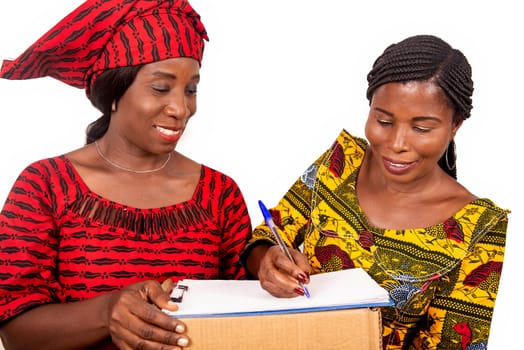 beautiful mature woman messenger carrying a large package while the business woman confirming receipt of delivery by signing