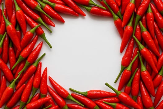 AI generated vibrant image of fresh red chili peppers arranged in circular pile, showcasing their fresh garden-picked quality against clean white background