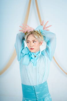 an Asian woman with glowing makeup posing very elegantly in a white room