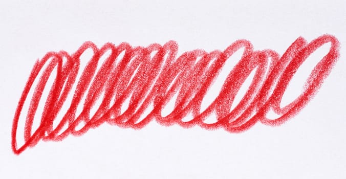 Hand drawn red scribble mark made with crayon or colored pencil on white textured paper