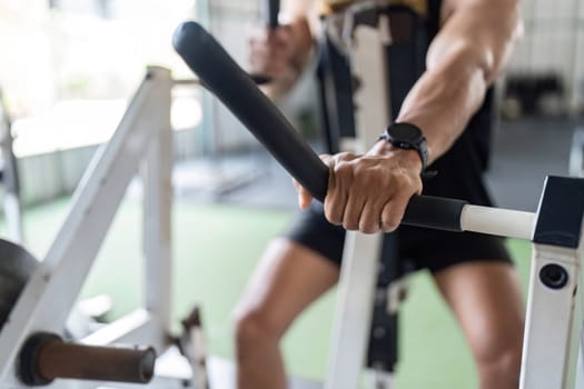 A close-up view of a strong hand gripping gym equipment, highlighting strength training and fitness dedication.