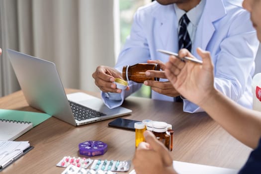 A doctor shares medication details with colleagues during a team meeting, emphasizing collaboration in patient care.
