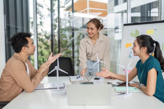 A diverse team discusses ESG strategies and sustainable practices, showcasing data in a modern office environment.