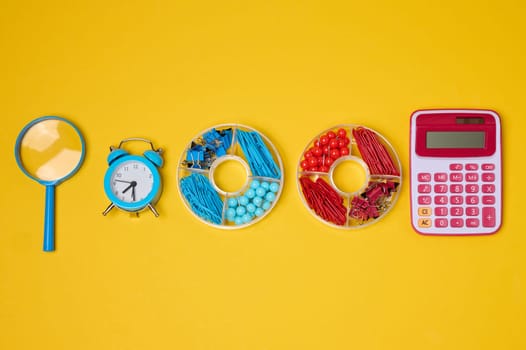 Vibrant collection of colorful school supplies and learning items on a yellow background. Play and education concept.