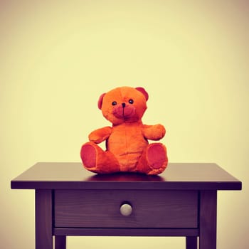a teddy bear on a table on a beige background, with a retro effect