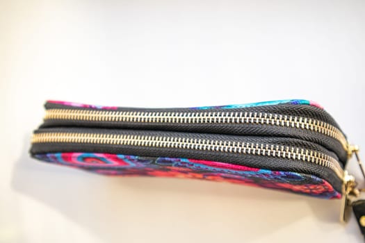 Closed women's textile purse on white background. Selective focus.