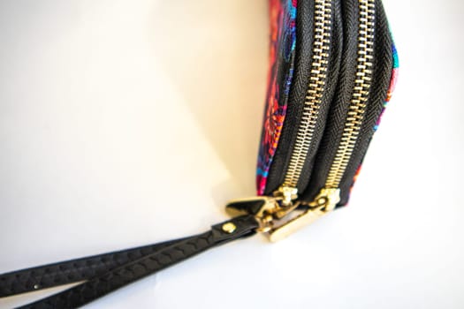 Closed women's textile purse on white background. Selective focus.