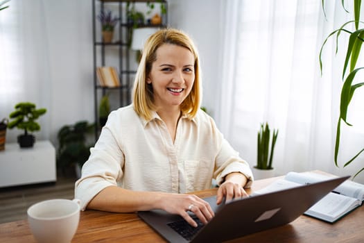 Woman engaged in productive work at a cozy workspace.