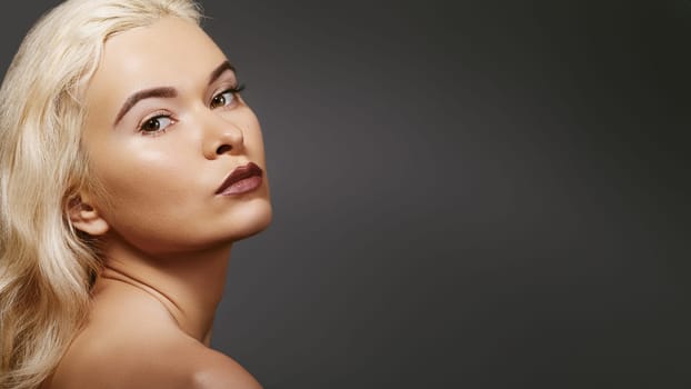 Portrait of sexy blond woman in retro style. Natural beauty with pure skin on beige background. Beautiful woman model in femininity pose with fashion make-up, hairstyle