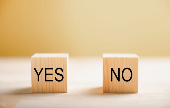 Representation of yes or no choice on wooden blocks. Demonstrates business and lifestyle concepts. Decision-making visualized. Think With Yes Or No Choice.