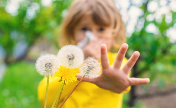 The child is allergic to dandelions. Selective focus. Kid.