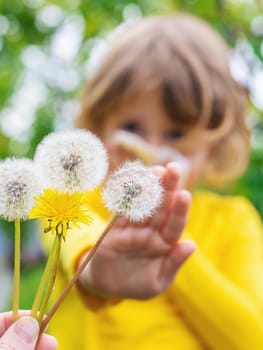 The child is allergic to dandelions. Selective focus. Kid.