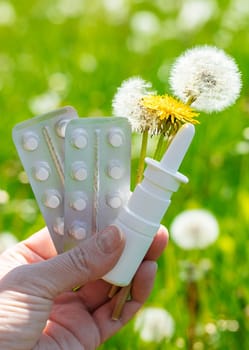 Allergy remedies in hands. Selective focus. Kid.