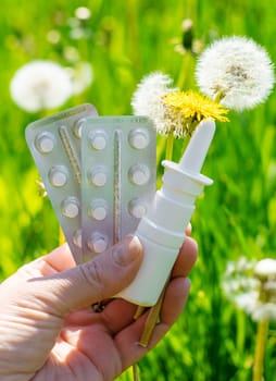 Allergy remedies in hands. Selective focus. Kid.